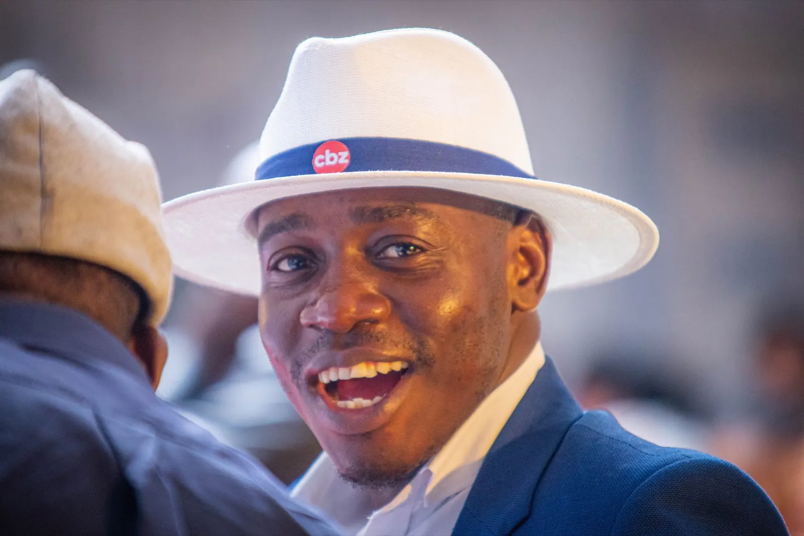 A smiling delegate in a white hat at the ZAPF conference
